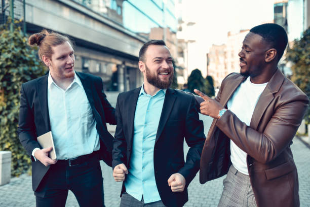 istock Happy Elegant Multiethnic Businessmen Friends Taking A Walk After Work 1489168031