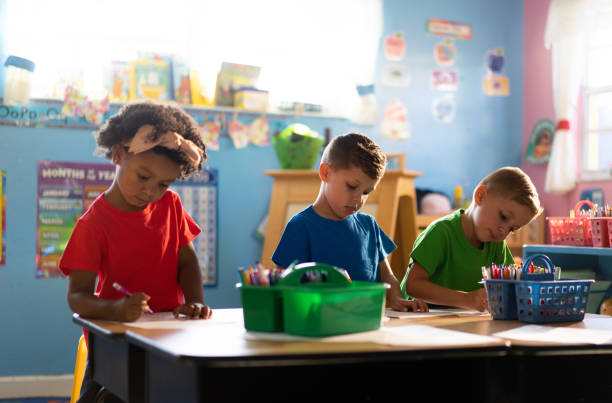 istock Three kids coloring at a daycare school 1489170001