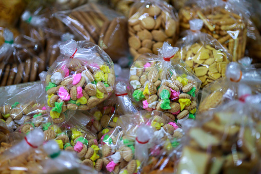 A variety of traditional Malaysian biscuits are packed in a plastic bag for sale at a local market.