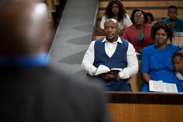 istock Over shoulder preacher to listening congregation 1489173153