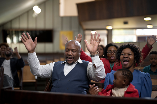 Multi-generation family and congregation enjoying church service