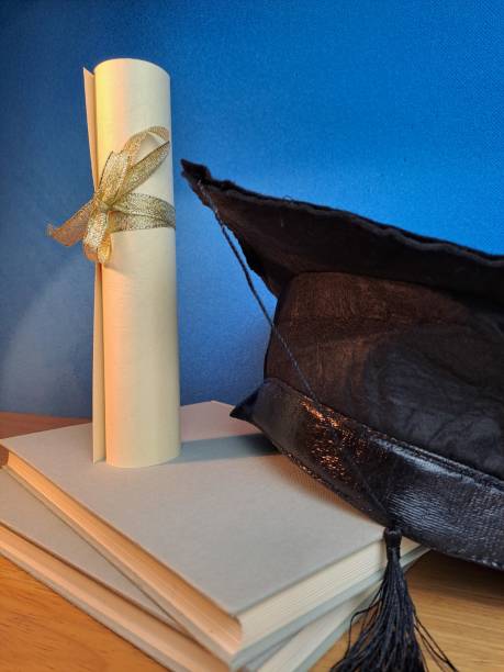 istock Graduation hat with degree paper on a stack of books. Copy space end Chroma key 1489176900