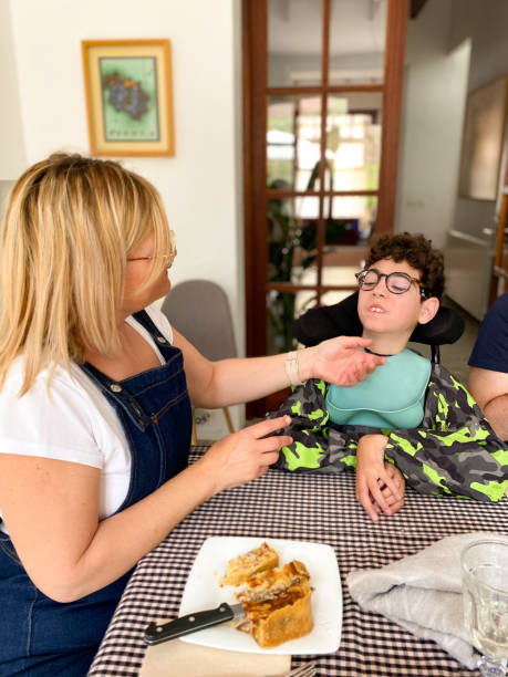 istock Mom feeding her son with cerebral palsy 1489177857