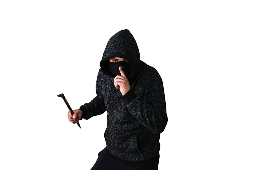 Criminal with crowbar isolated on white background. Robber in dark hoodie. .