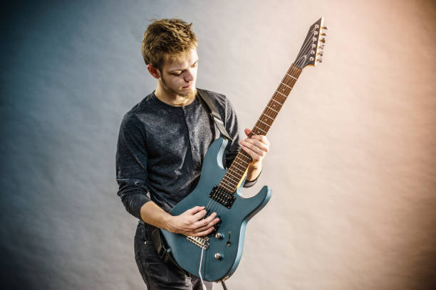 istock Young man playing electric guitar 1489181256