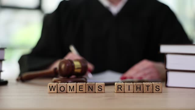 Book about women rights on table of judge in court