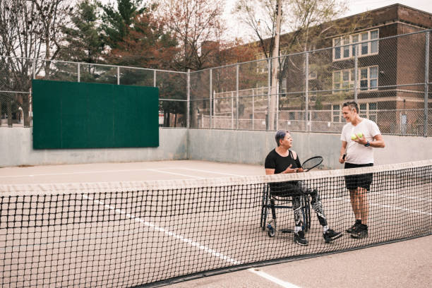 istock Disabled Latin woman practice tennis with coach 1489184021