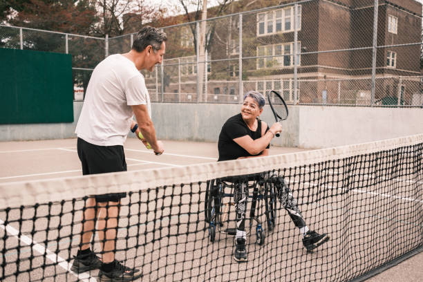 istock Disabled Latin woman practice tennis with coach 1489184050