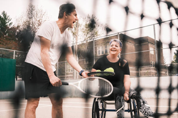 istock Disabled Latin woman practice tennis with coach 1489184086