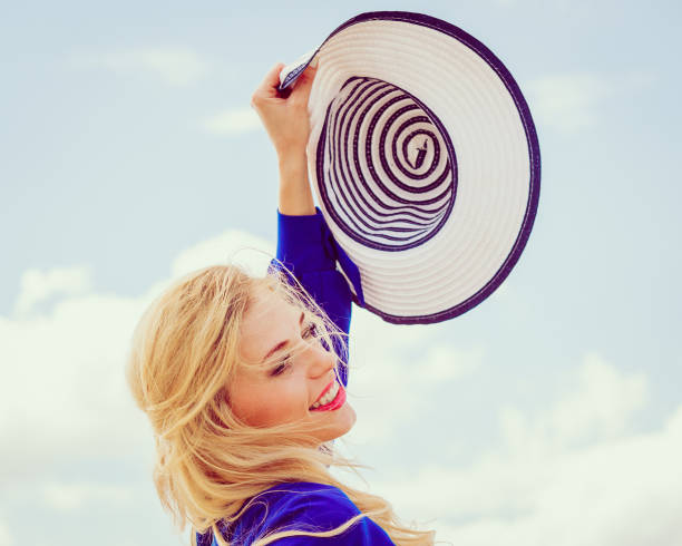 istock Fashion model posing with sun hat 1489184650