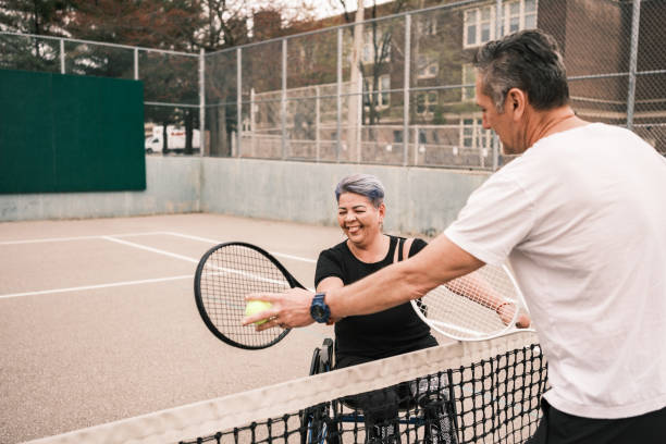 istock Disabled Latin woman practice tennis with coach 1489184657