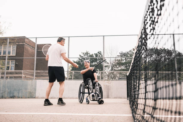 istock Disabled Latin woman practice tennis with coach 1489185500