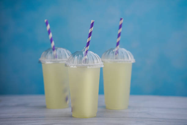 Beautiful lemon juice isolated on blue background, Fresh lime juice image