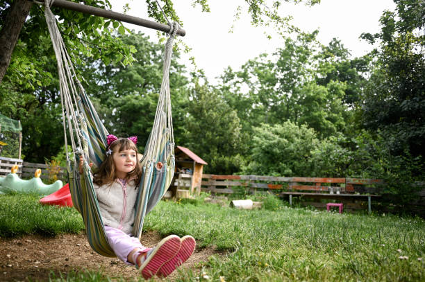 istock preschool girl in hammock in backyard. 1489186894