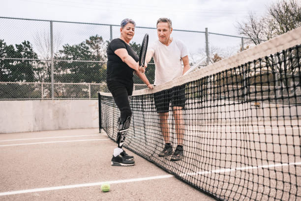 istock Disabled Latin woman practice tennis with coach 1489186941