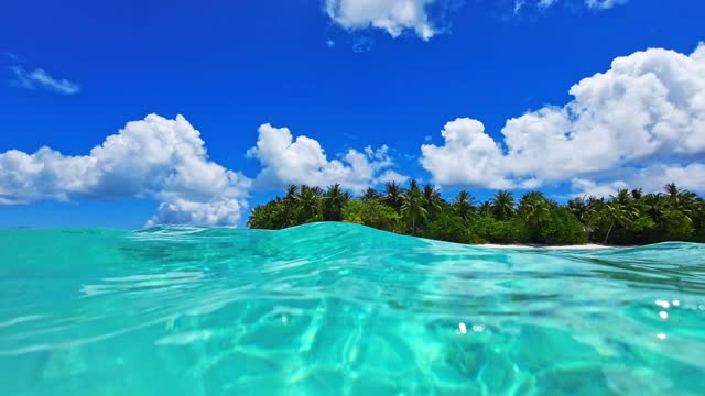 Low angle view of tropical island from ocean