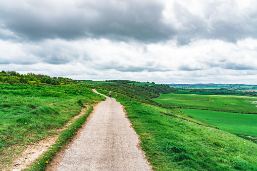 Path on hilly landscape on cloudy day in summer at Dunstable Downs, UK