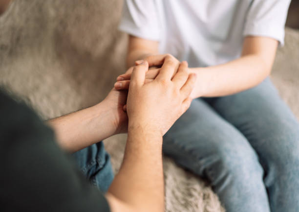 istock Psychologist and lady hold each other's hands, support for a loved one 1489189419