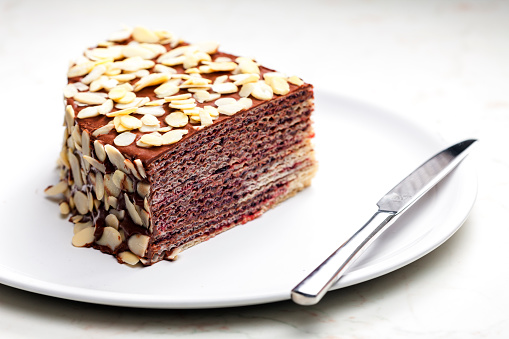 buiscuit cake with dark chocolate decorated with almonds