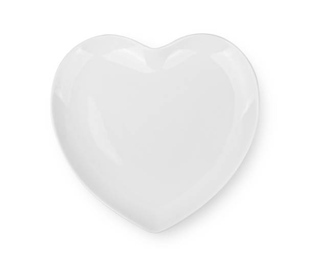 istock white plate in shape of heart on white background 1489192506
