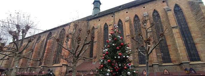 Image of a Christmas Tree and a church in the village of Colmar