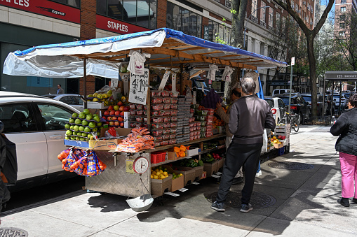 New York, USA, April 11, 2023 - Street food stand for fruits and vegetables on Lexington Ave in New York Manhattan.