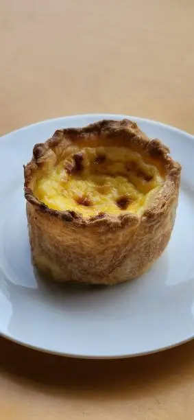 a close-up shot of Desert, eggtart on white plate in a cafe