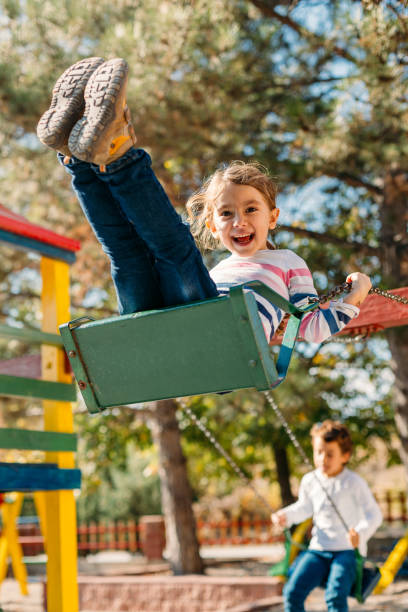 Happy children swinging in the park