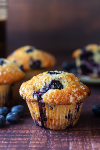 freshly baked homemade blueberry muffins on wooden table background.