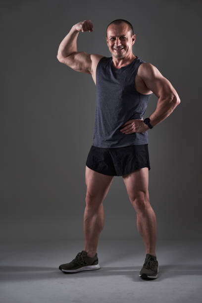 Body Builder Flexing Muscles and Exercise With Weights