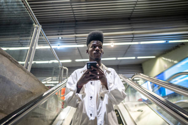 istock Young man using the mobile phone at the subway station 1489202952