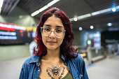 Portrait of a young woman at the subway station