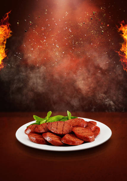 salchichas sobre un fondo caliente y picante - salt sausage fire flame fotografías e imágenes de stock