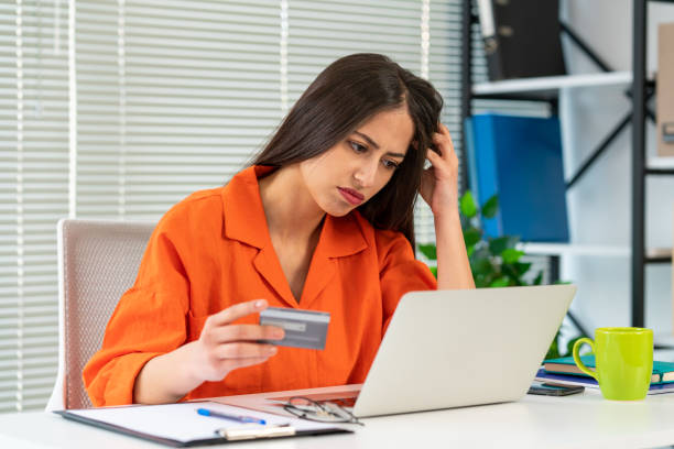 Financial problems, unsuccessful online shopping. Shocked woman with laptop and credit card Financial problems, unsuccessful online shopping. Shocked woman with laptop and credit card credit card women internet currency stock pictures, royalty-free photos & images