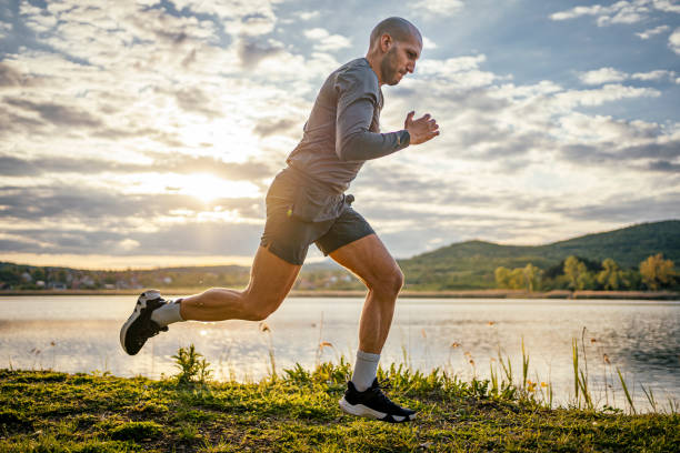 istock Sporty man running by the lake 1489205263