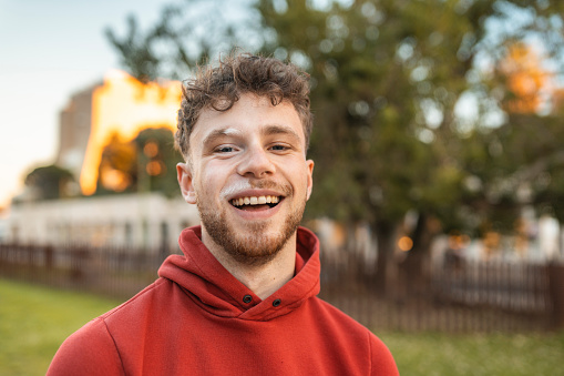 Portrait of the happy young man outdoors
