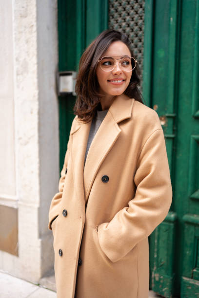 Friendly smiling attractive woman leaving building