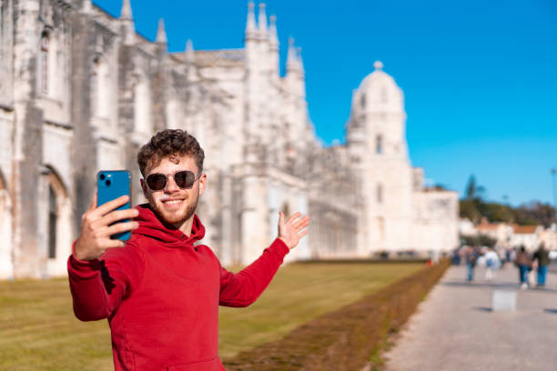istock Influencer recording a vlog showing the Jeronimos Monastery 1489207331
