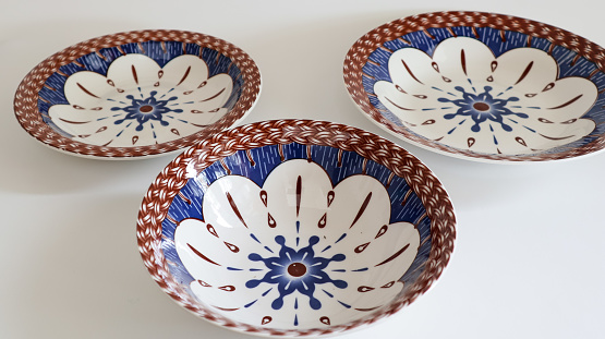 ceramic bowl with a pattern, on a white table, white background