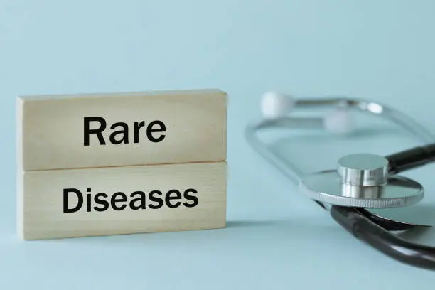 Photo of Rare diseases written on wooden blocks together with medical stethoscope, Health concept