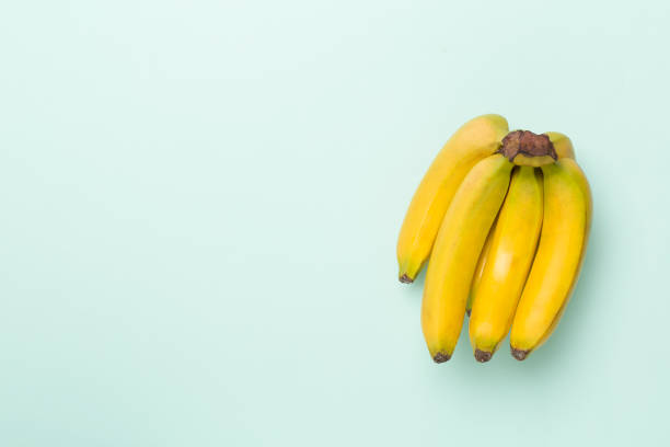 istock Fresh bananas on color background, top view 1489214645