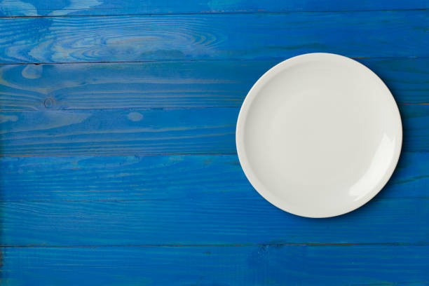 istock Empty round plate on wooden background, top view 1489214774
