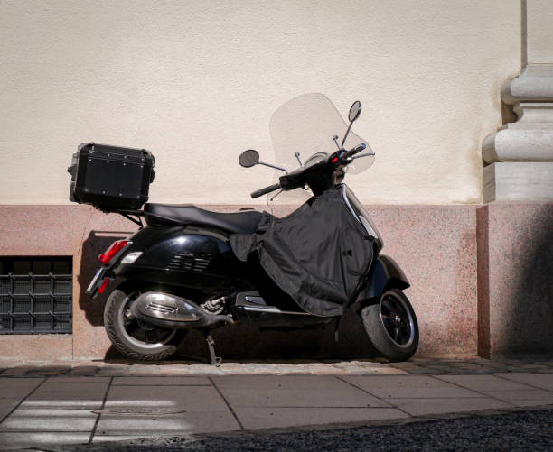 istock a black scooter is parked on the side of a building 1489215189