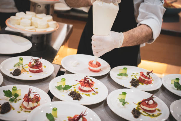 istock Chefs prepare tomato and mozzarella salad with cream at hotel buffet 1489215876
