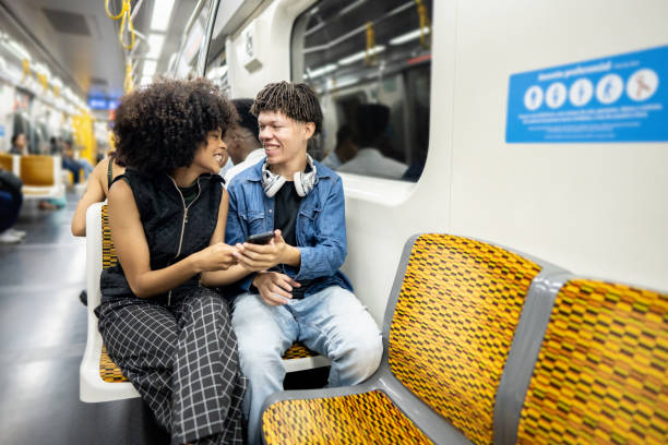 istock Friends using the mobile phone on the subway train 1489218842