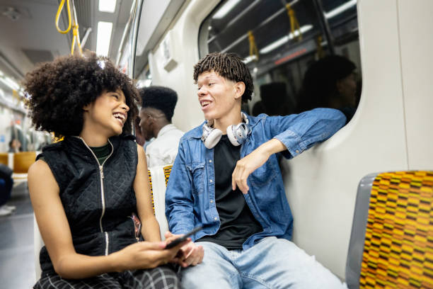 istock Friends using the mobile phone on the subway train 1489218843