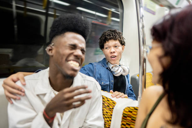 istock Young man talking to friends on the subway train 1489218902