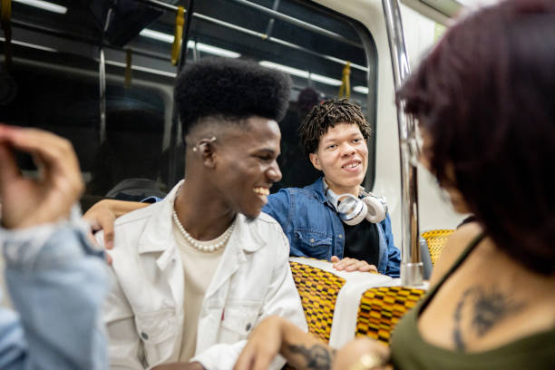 istock Young man talking to friends on the subway train 1489218929