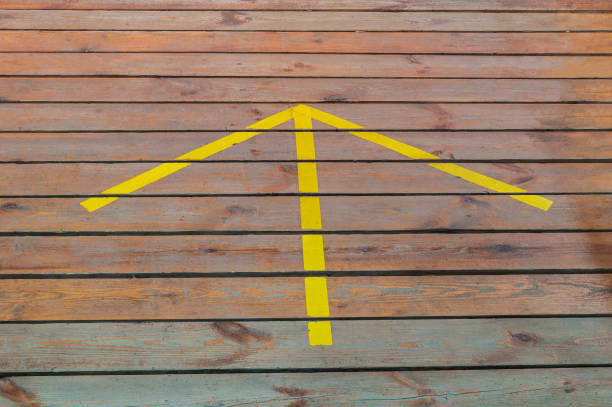 Yellow arrow on the wooden floor