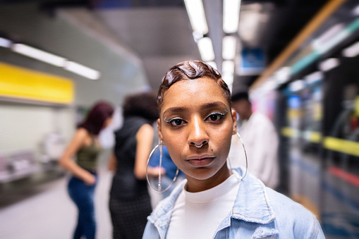 Portrait of a young woman at the subway station